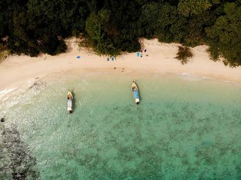 High angle view of people enjoying in sea