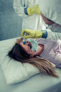 High angle view of woman lying on bed