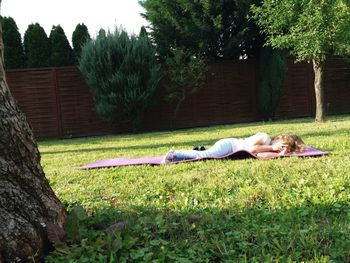 Woman lying on grass in lawn