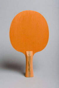 Close-up of orange table against white background