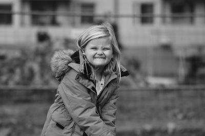 Portrait of smiling girl standing outdoors