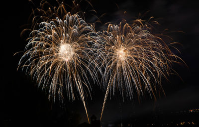 Low angle view of firework display at night