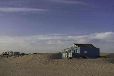 Houses on beach against sky