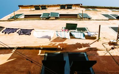 Low angle view of clothes drying on building
