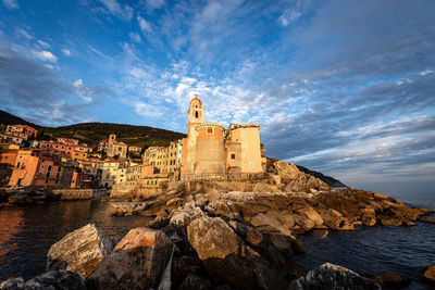 Historic building by sea against sky