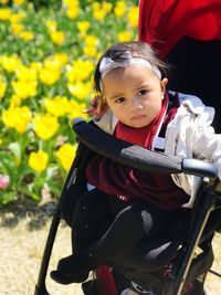 Portrait of smiling girl sitting in stroller