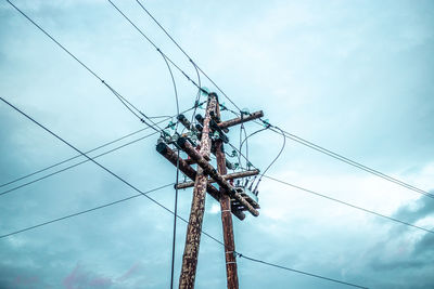 Low angle view of electricity pylon against sky