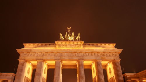 Low angle view of illuminated building at night