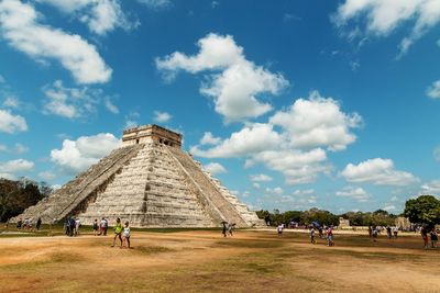 Tourists against blue sky