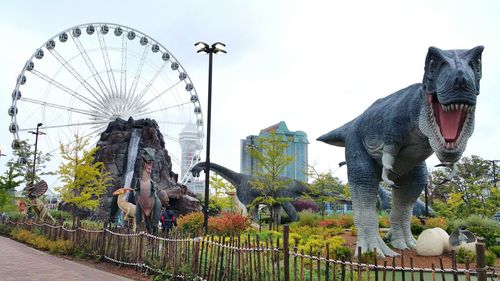 Statue in amusement park against clear sky