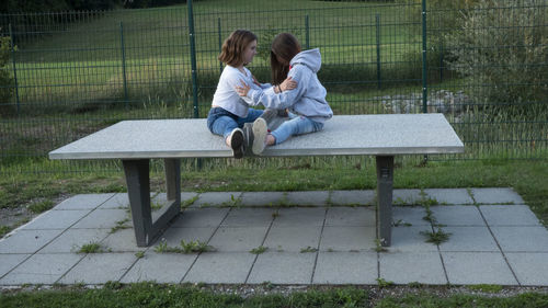 Woman sitting on bench in park