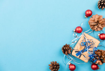 Christmas decorations on table against blue background