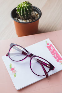 Book and eyeglasses on table