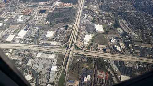 Aerial view of buildings seen through airplane glass window