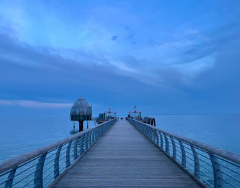 Pier over sea against sky