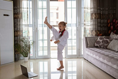 Woman standing by window at home