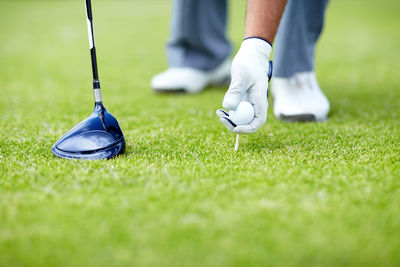 Low section of man playing golf