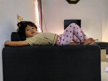 Rear view of woman sitting at home