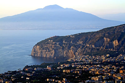 High angle view of townscape by sea against sky