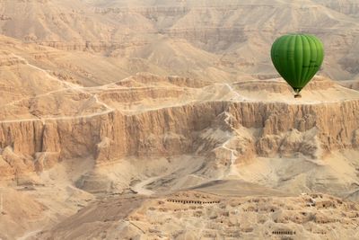 Hot air balloon flying over mountain