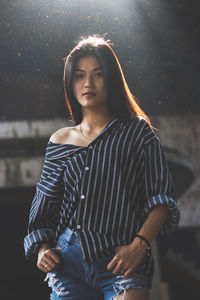 Young woman standing in abandoned building