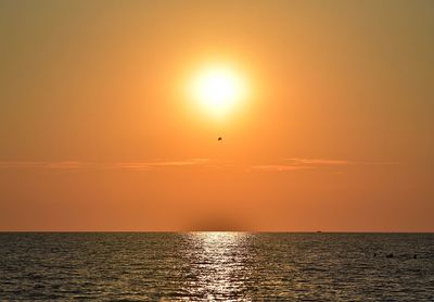 Scenic view of sea against orange sky