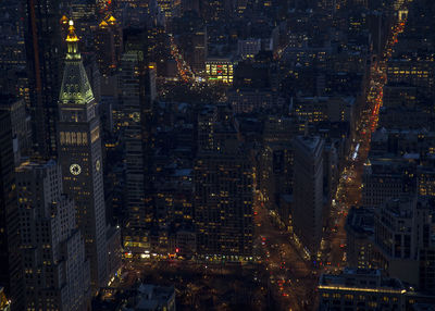 Aerial view of city lit up at night