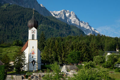 Church by mountains against sky