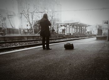 Woman walking on railroad track
