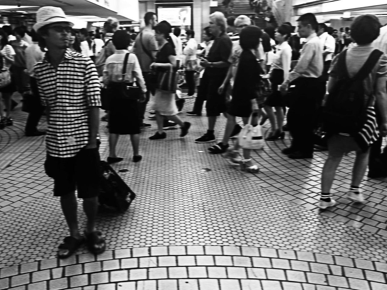 large group of people, men, person, walking, lifestyles, city life, street, leisure activity, city, full length, medium group of people, tiled floor, mixed age range, casual clothing, built structure, togetherness, architecture, sunlight, day