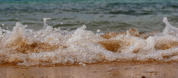 Close-up of waves splashing on beach