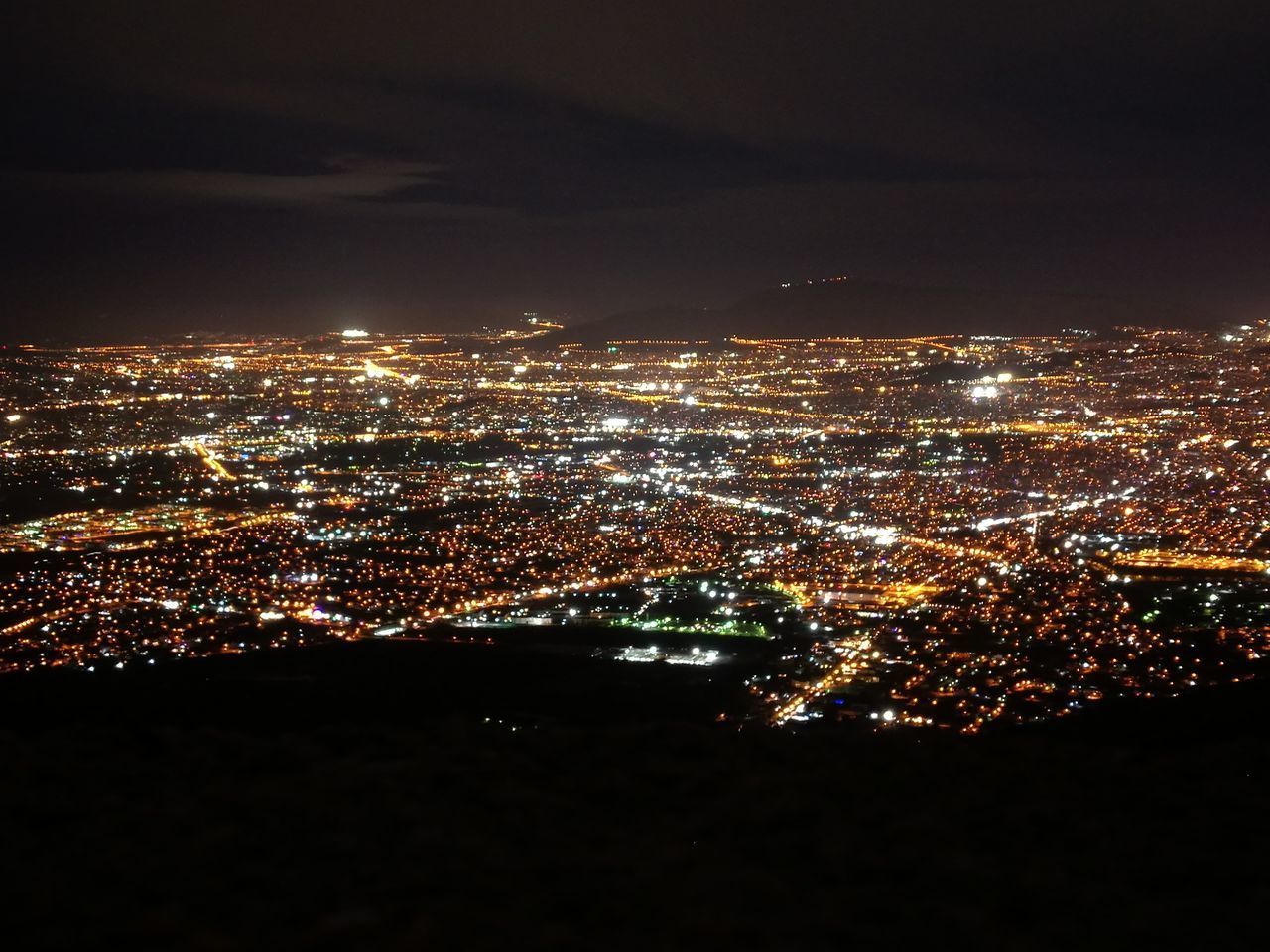 AERIAL VIEW OF ILLUMINATED CITYSCAPE