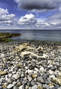 Rocks on beach against sky