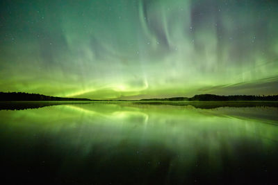 Scenic view of lake against sky at night