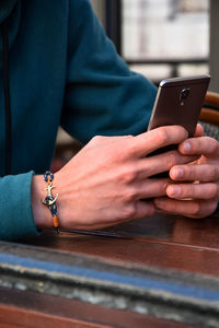 Midsection of woman using mobile phone