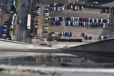 Tilt-shift image of cars at parking lot