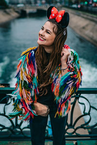 Portrait of smiling young woman standing outdoors