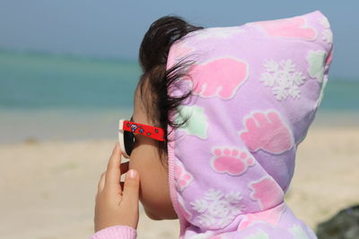 Close-up of girl wearing sunglasses at beach