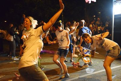 Rear view of people enjoying at night