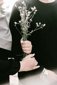 Close-up of hand holding flower