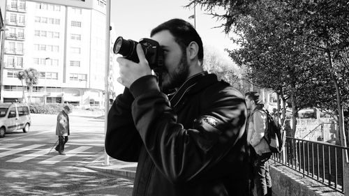 Man standing in city against sky