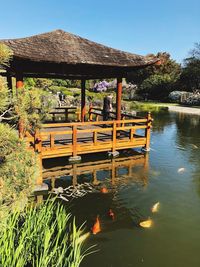 Gazebo by lake against sky