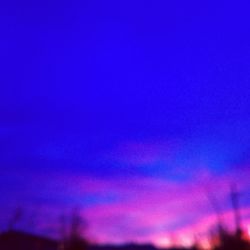 Low angle view of illuminated blue sky at night