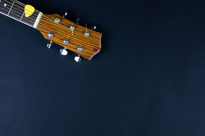 High angle view of guitar against black background