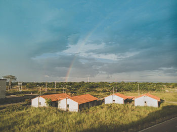 Houses on field against sky