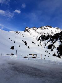 Scenic view of snow covered mountains against sky
