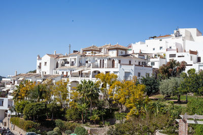 View of townscape against clear blue sky