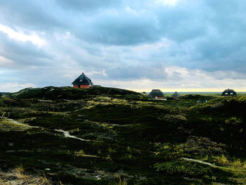 Traditional building on mountain against sky