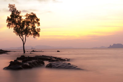 Scenic view of sea against sky at sunset