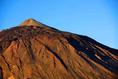 Rocky mountain at el teide national park against clear blue sky